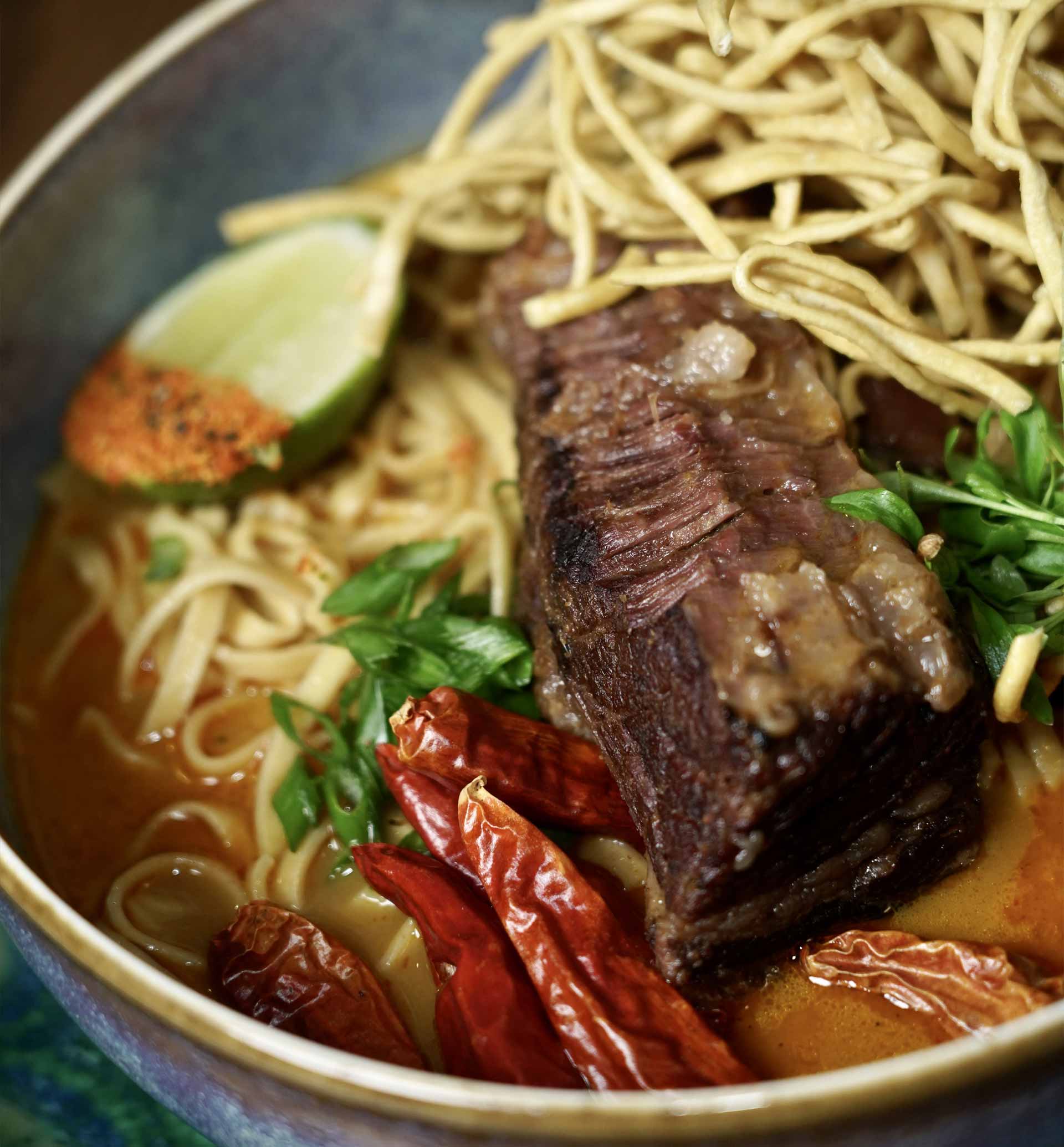 Premium braised-beef, slow cooked in a red-curry coconut-cream broth, topped with egg noodles and cilantro